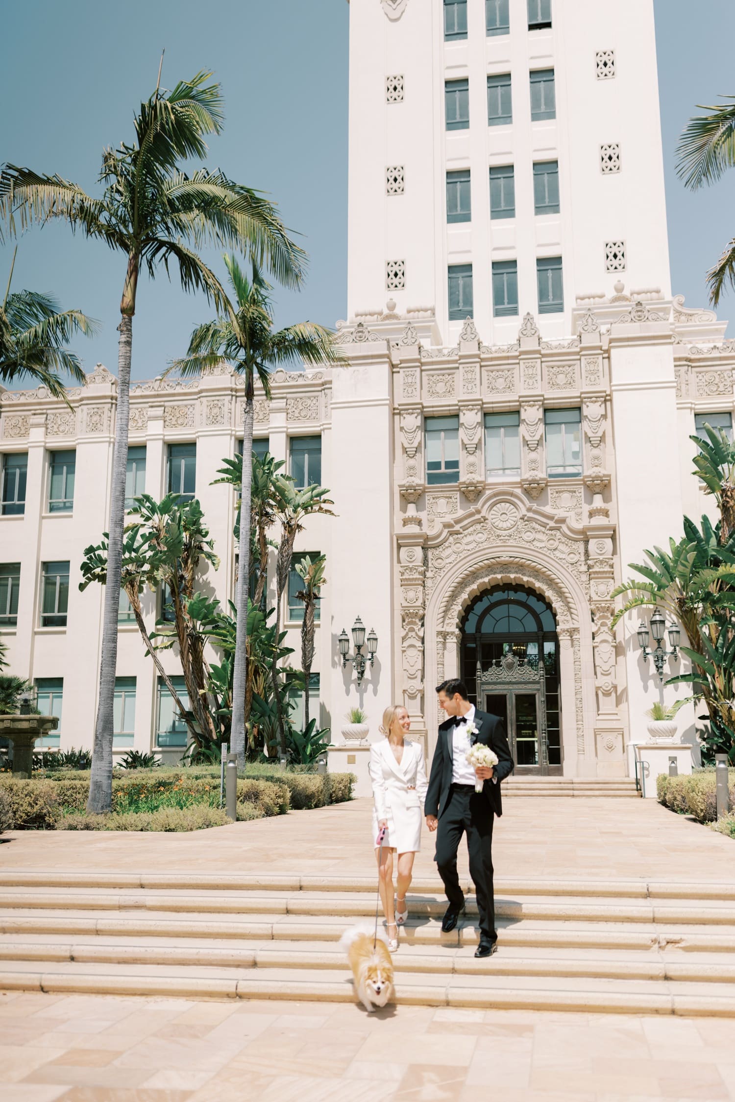 Newly married couple outside Los Angeles County Registrar-Recorder County Clerk in downtown Los Angeles, celebrating after civil ceremony, holding marriage certificate and bouquet, courthouse wedding photography, urban city backdrop, emotional joyful moment, Southern California courthouse wedding, Getting Married at the Old Orange County Courthouse, Getting married at the Beverly Hills Courthouse, Checklist for your Beverly Hills Courthouse, How to get Married at the Beverly Hills Courthouse